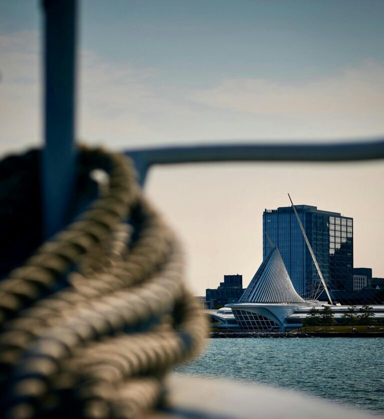 View of Milwaukee Art Museum with foreground focus on boat's rope, blending architecture and maritime vibes.